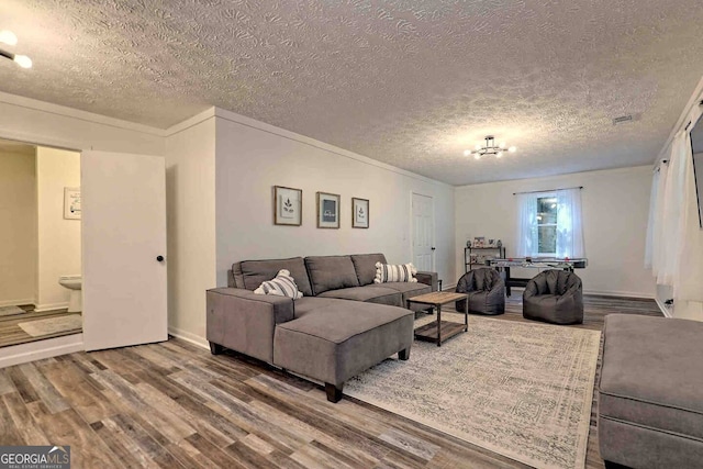 living room with wood-type flooring and a textured ceiling