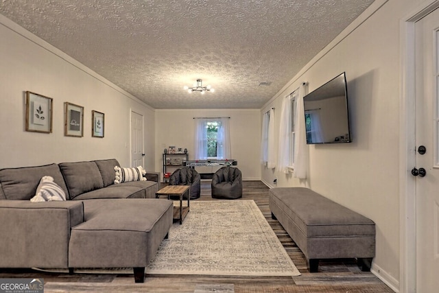 living room featuring ornamental molding, a textured ceiling, and dark hardwood / wood-style flooring