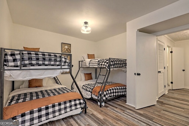 bedroom featuring hardwood / wood-style flooring and a closet