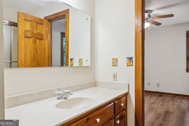 bathroom with vanity, hardwood / wood-style flooring, and ceiling fan