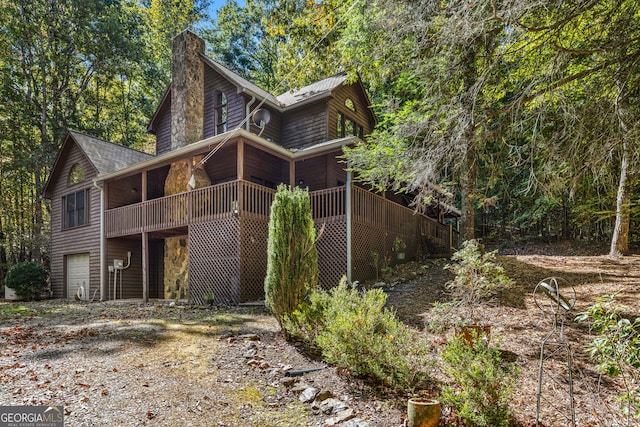 rear view of property featuring a deck