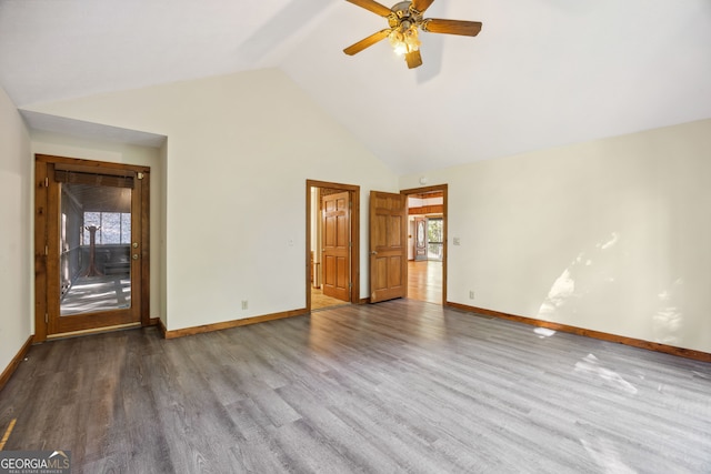 spare room with ceiling fan, high vaulted ceiling, a wealth of natural light, and hardwood / wood-style floors