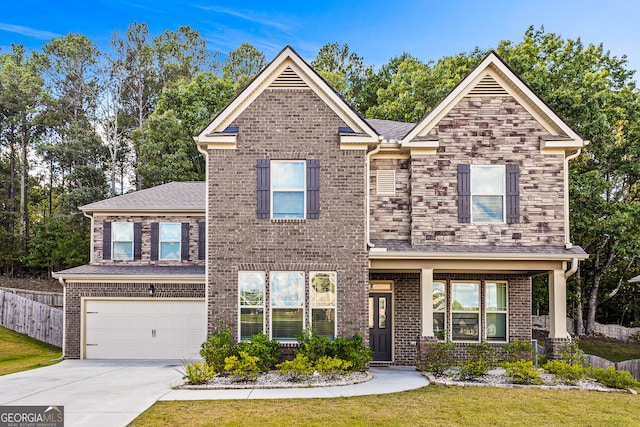 view of front of house featuring a garage and a front lawn