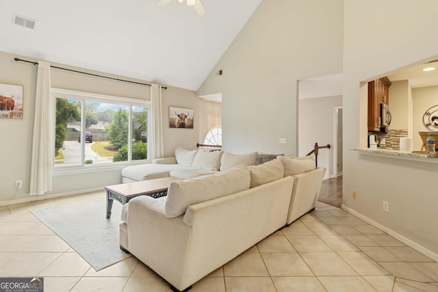 tiled living room with high vaulted ceiling and ceiling fan