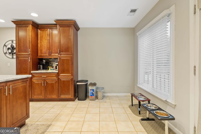 kitchen featuring light tile patterned floors and a wealth of natural light