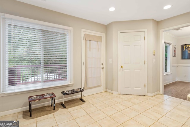 tiled entrance foyer with crown molding