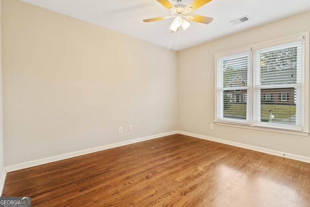 empty room with ceiling fan and wood-type flooring