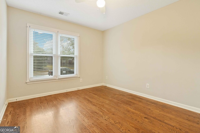 spare room featuring hardwood / wood-style floors and ceiling fan