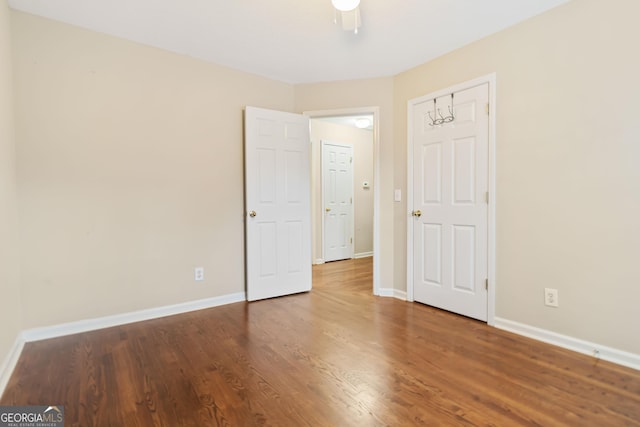 unfurnished bedroom featuring wood-type flooring and ceiling fan