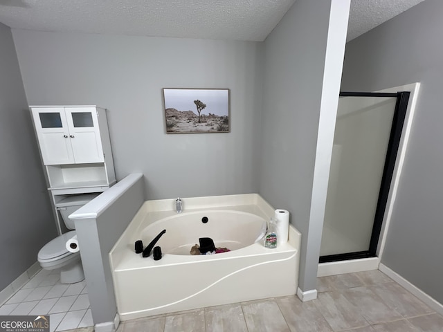 bathroom with tile patterned floors, a textured ceiling, toilet, and independent shower and bath