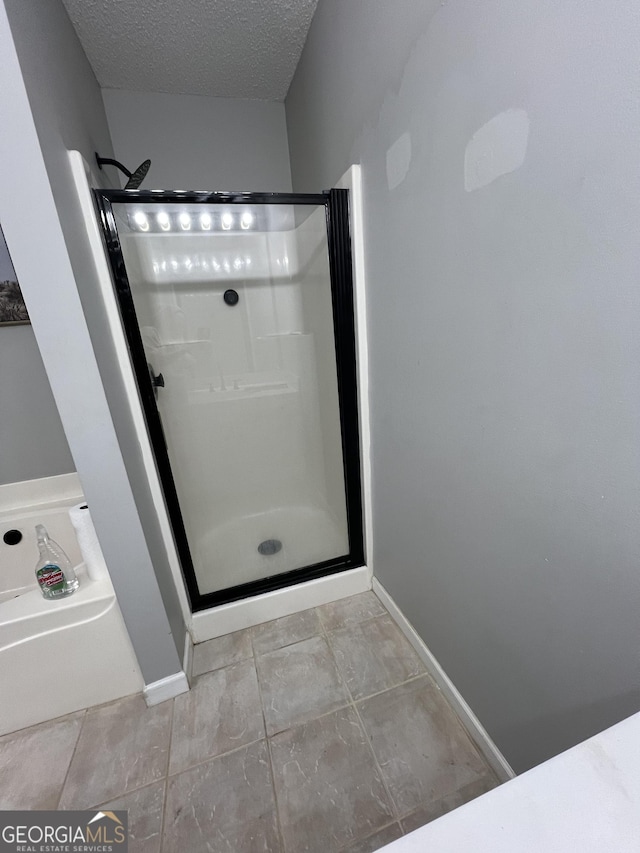 bathroom with plus walk in shower, a textured ceiling, and tile patterned floors