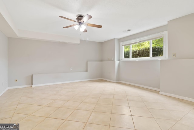 tiled empty room with ceiling fan