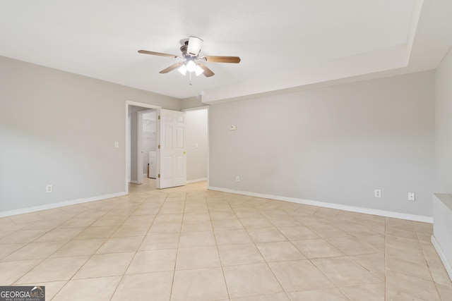 tiled empty room featuring ceiling fan