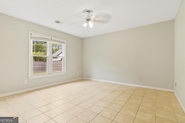 empty room featuring ceiling fan and light tile patterned flooring