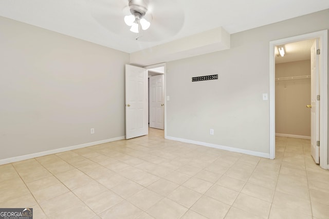 unfurnished room featuring ceiling fan and light tile patterned floors