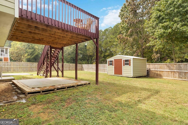 view of yard with a storage shed and a deck