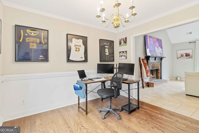 office featuring a brick fireplace, ornamental molding, hardwood / wood-style flooring, a chandelier, and lofted ceiling