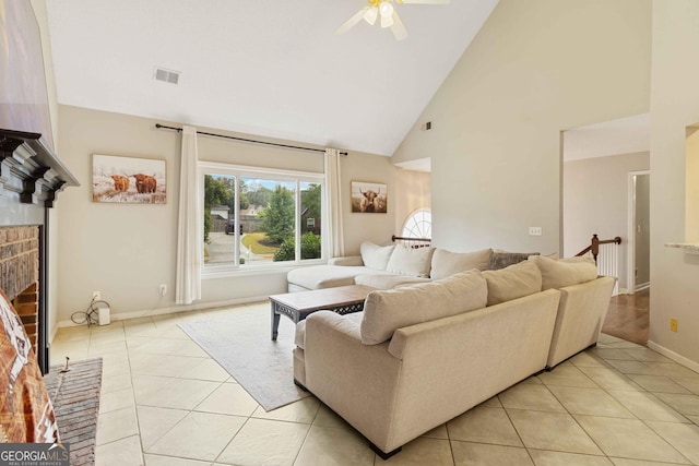 tiled living room with a fireplace, high vaulted ceiling, and ceiling fan