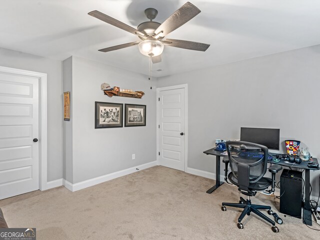 office space featuring ceiling fan and light colored carpet