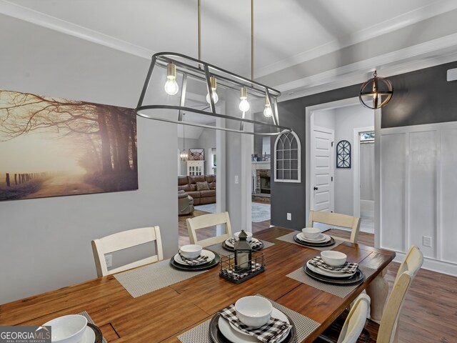 dining room with ornamental molding and hardwood / wood-style flooring