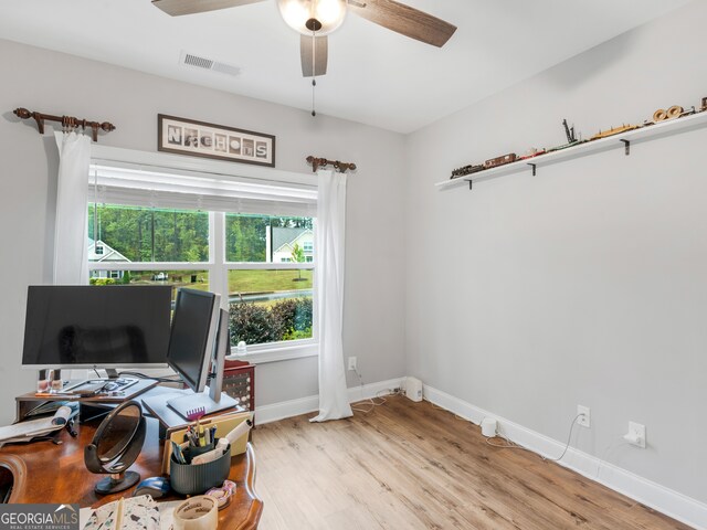 office with light hardwood / wood-style floors and ceiling fan