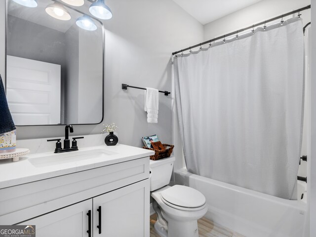 full bathroom with vanity, toilet, and shower / bath combination with curtain