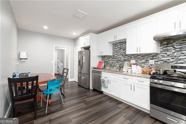 kitchen featuring ventilation hood, stainless steel appliances, dark hardwood / wood-style flooring, and white cabinetry