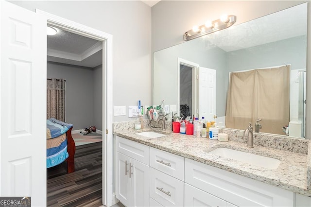 bathroom with vanity, a textured ceiling, and hardwood / wood-style flooring