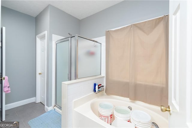 bathroom with a textured ceiling, shower with separate bathtub, tile patterned flooring, and decorative backsplash