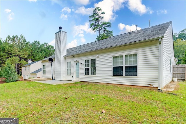 back of house with a yard and a patio area