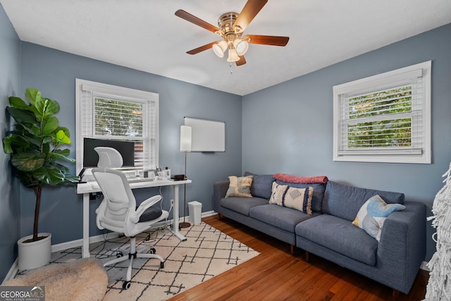 office featuring a wealth of natural light, wood-type flooring, and ceiling fan