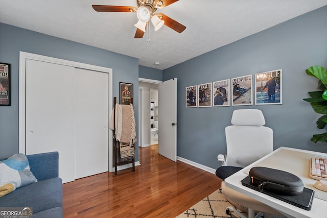 office featuring wood-type flooring and ceiling fan