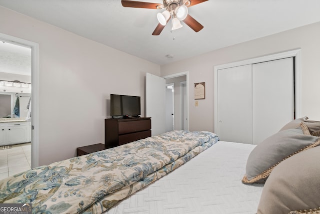 bedroom featuring ceiling fan, ensuite bath, and a closet