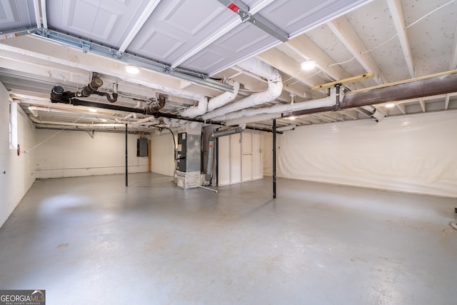 basement with electric panel and heating unit