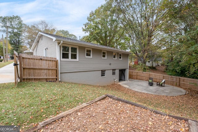 rear view of house featuring a yard and a patio area