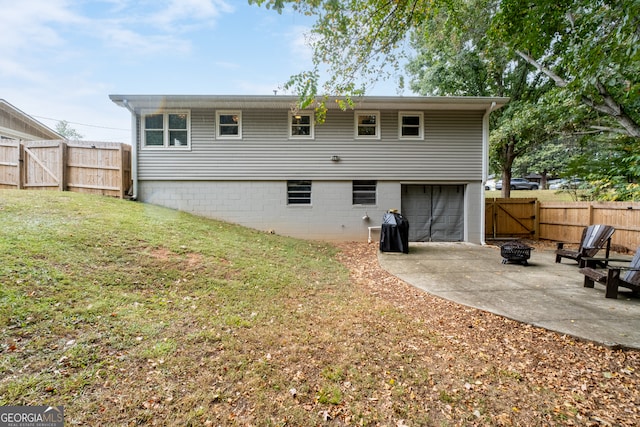 back of house featuring a patio area and a lawn