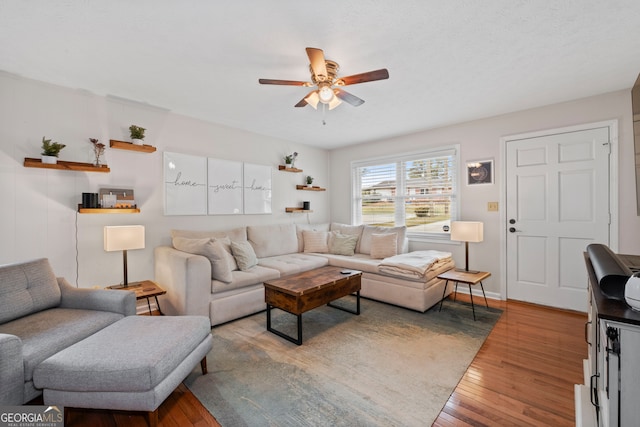 living room with wood-type flooring and ceiling fan