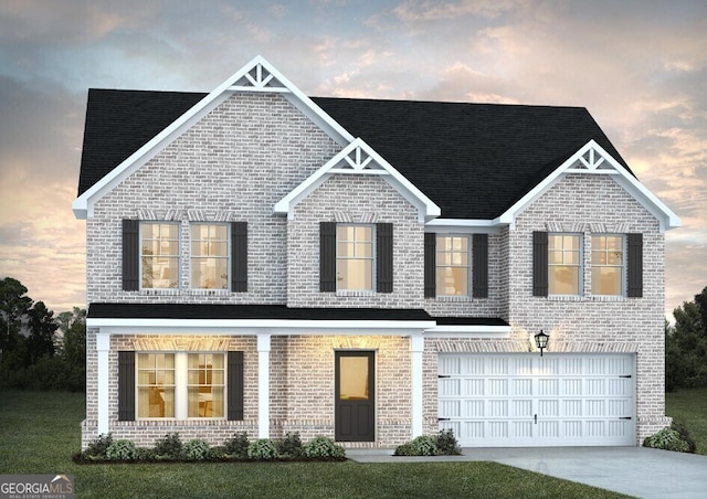 view of front of house with a yard and a garage