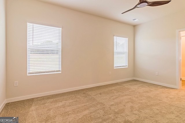 empty room featuring light colored carpet and ceiling fan