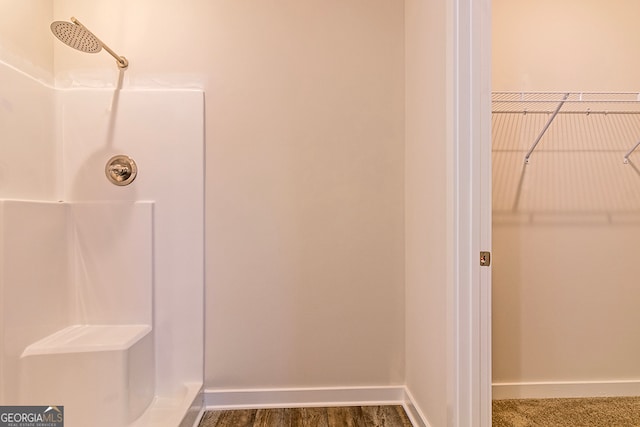 bathroom with walk in shower and hardwood / wood-style flooring