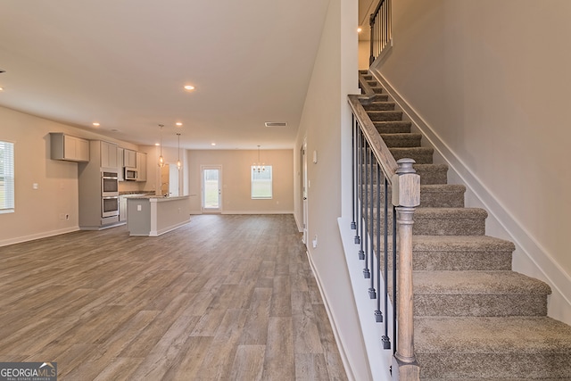 stairway featuring wood-type flooring