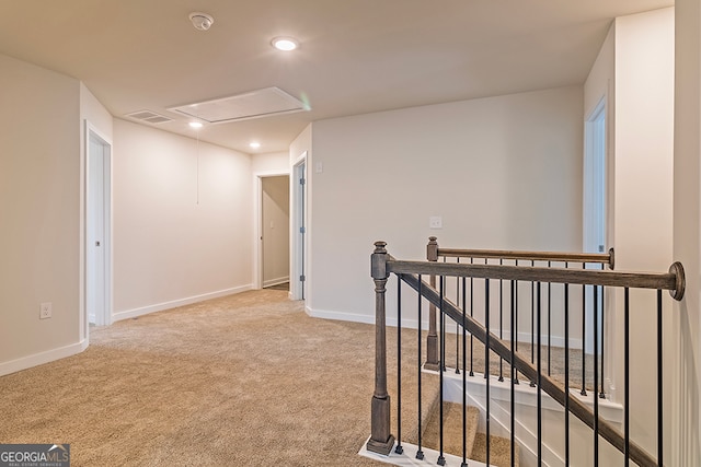 corridor featuring light colored carpet