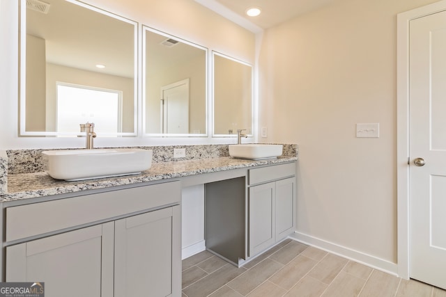 bathroom featuring vanity and hardwood / wood-style flooring