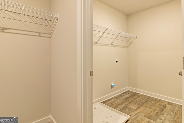 washroom with electric dryer hookup and hardwood / wood-style floors