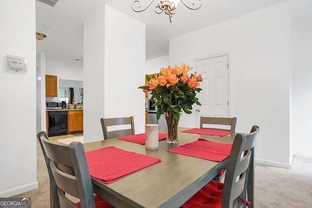 carpeted dining space with an inviting chandelier