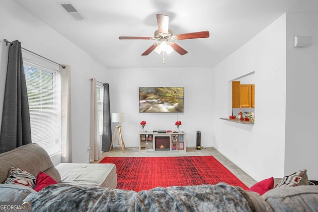 carpeted living room with ceiling fan