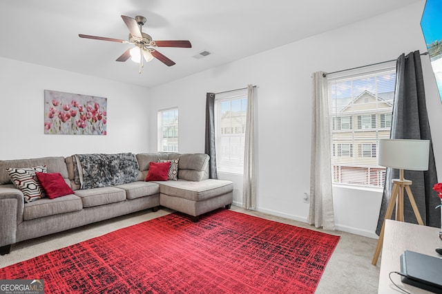 carpeted living room featuring ceiling fan