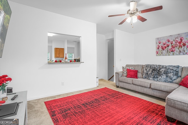 living room featuring ceiling fan and light colored carpet