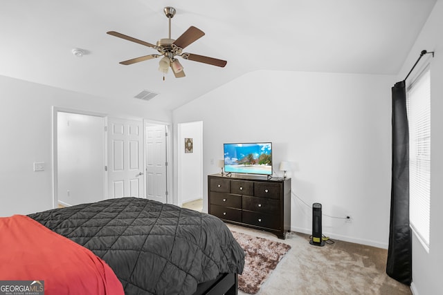 bedroom with lofted ceiling, ceiling fan, and light colored carpet