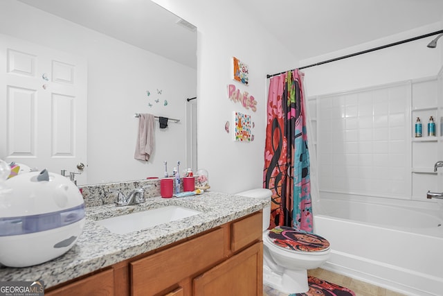 full bathroom with shower / tub combo with curtain, tile patterned floors, vanity, and toilet